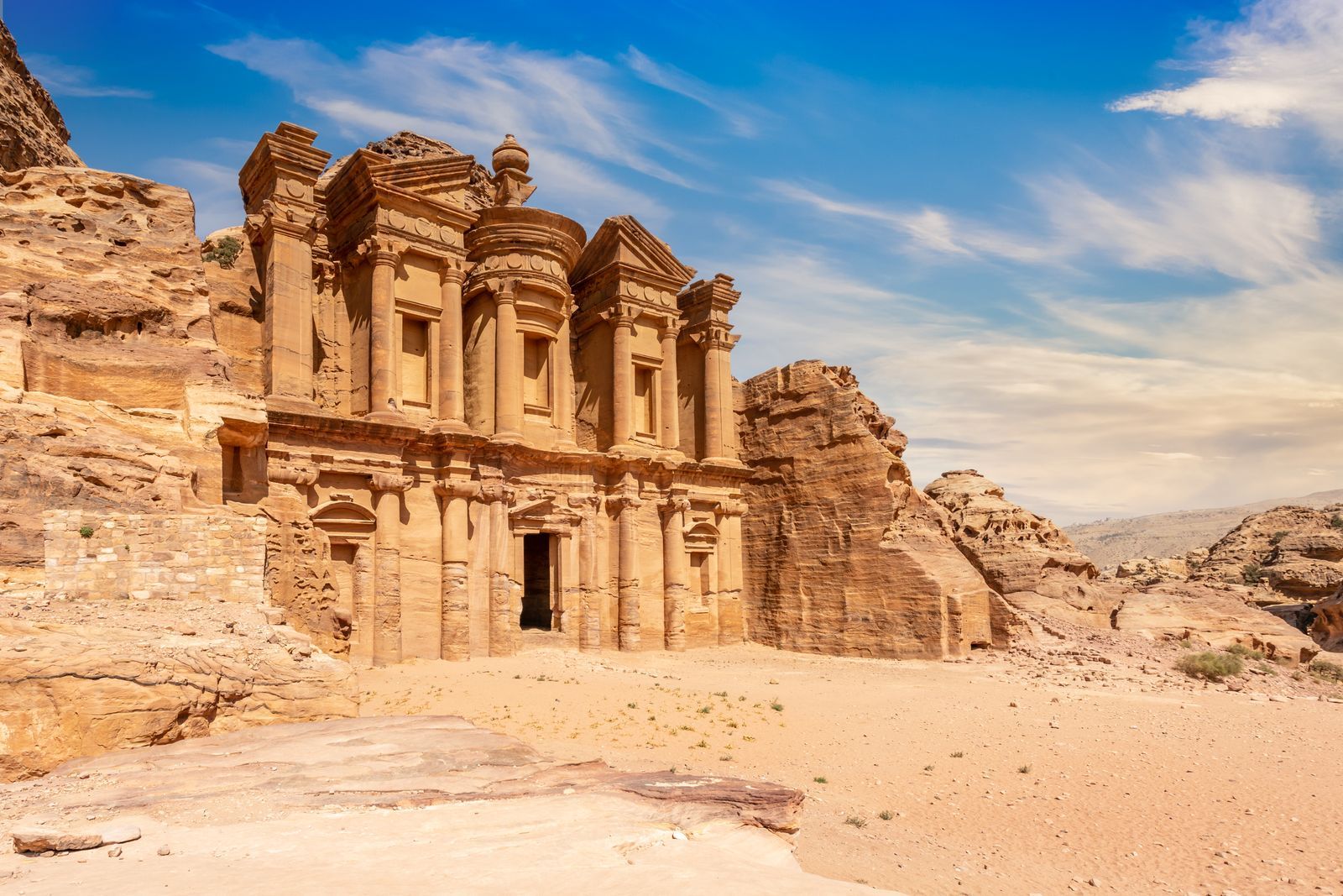 Historic rock cut tombs and mountain scenery in Petra Jordan