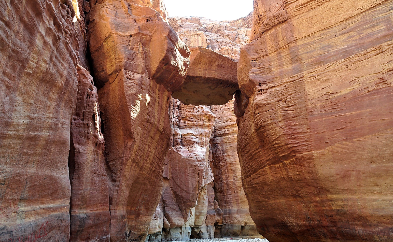 Wadi Numeira canyon Jordan with narrow sandstone walls and flowing water